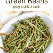 A tray of roasted green beans with sliced shallots and red pepper flakes, perfectly blistered and seasoned.