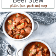 A steaming bowl of thick beef stew with chunks of beef, carrots, and potatoes in a rich brown gravy, garnished with fresh parsley."