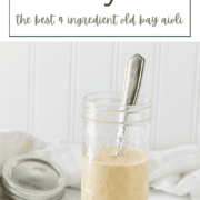 A small glass mason jar filled with creamy, orange-tinted Old Bay aioli.