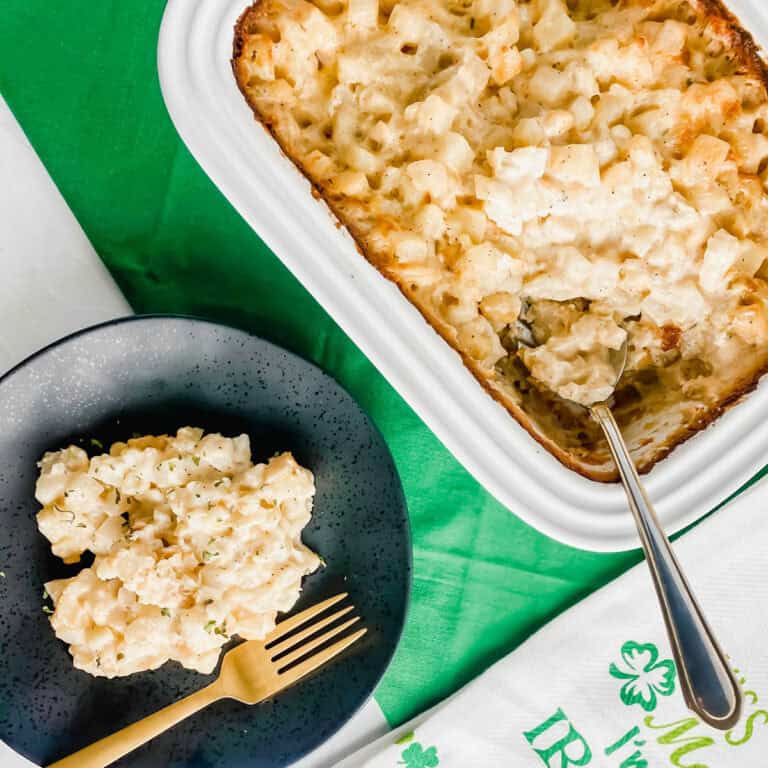 Irish Potatoes is a white dish, with a serving on a black plate with a gold fork. There is a white towels that says "kiss me I am Irish". https://www.atwistedplate.com/irish-potatoes/